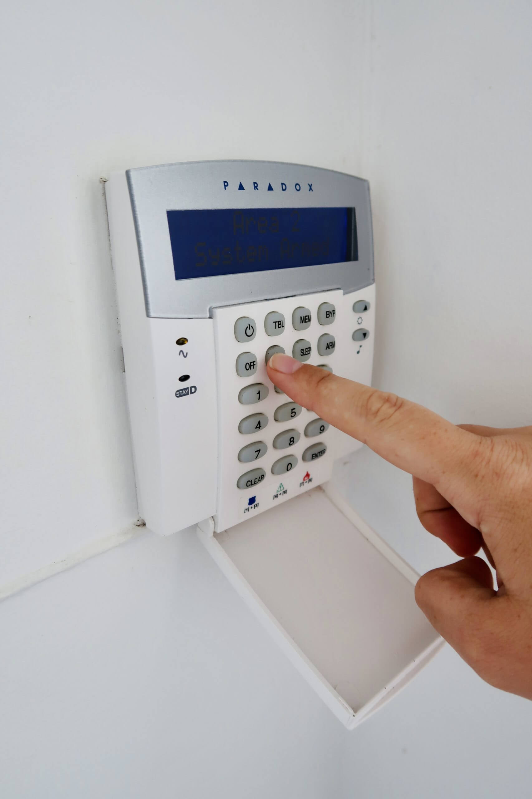 Alarm system keypad with hand pushing button